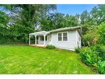 Charming home featuring a welcoming front porch, green lawn, and mature trees creating a serene setting at 1649 Nw Ezra Church Nw Dr, Atlanta, GA 30314