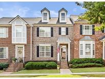 Charming brick townhome featuring classic architectural details and well-manicured landscaping at 1641 Perserverence Hill Nw Cir, Kennesaw, GA 30152