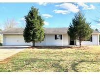 Charming single-story home featuring an attached garage and a well-maintained lawn at 2433 Robin Ridge Dr, Dacula, GA 30019