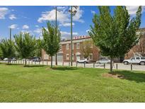 A striking brick building, lush greenery, and streetscape showcase this mixed-use property at 320 Martin Luther King Jr Se Dr # 9, Atlanta, GA 30312