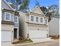 Charming two-story home featuring a white garage door, complemented by stone accents at 706 Smokey Quartz Way, Kennesaw, GA 30144