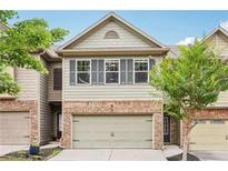 Charming townhome with a two-car garage and well-manicured landscaping at 146 Sunset Ln, Woodstock, GA 30189