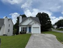 Charming single-Gathering home featuring a well-manicured lawn, neutral siding, and a cozy one-car garage at 133 Magazine St, Dallas, GA 30157