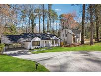 Charming renovated home with a porte-cochere and lush green lawn at 335 Amberidge Nw Trl, Atlanta, GA 30328