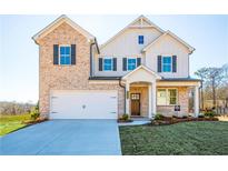 Inviting two-story home showcasing a brick facade, a two-car garage, and a meticulously landscaped front yard at 1795 Fulmont Cir, Mableton, GA 30126