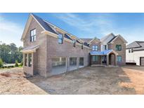 Spacious brick home with a three-car garage, dormers and covered front entry at 2395 Kilgore Road (Lot 7) Rd, Buford, GA 30519