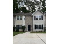 Charming two-story townhome featuring a brick facade, neutral siding, and a well-maintained front lawn at 5538 Pineridge Ct, Forest Park, GA 30297