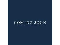 The text overlay reads 'Coming Soon', set against a solid dark blue background, indicating future availability at 717 Lenox Ln, Atlanta, GA 30324