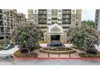 Inviting condo building entrance with meticulous landscaping and water feature, creating a welcoming atmosphere at 795 Hammond Dr # 503, Sandy Springs, GA 30328