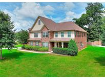 Attractive brick and siding two-story home with a well-maintained lawn and manicured landscaping at 2458 Brook Park Trl, Snellville, GA 30078