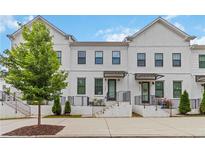 Modern townhome with white brick and siding, black framed windows, and stylish wrought iron railings at 2461 Sycamore Nw Rd, Atlanta, GA 30318