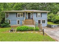 Charming split-level home with blue siding, inviting front porch, and well-maintained landscaping at 428 Medlock Rd, Decatur, GA 30030