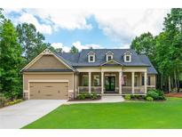 Charming single-Gathering home with manicured lawn, covered porch, and attached two-car garage at 516 Black Horse Cir, Canton, GA 30114