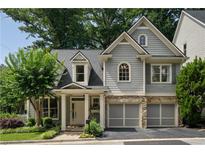 Charming two-story home with a well-manicured lawn and a two-car garage at 1360 Edmund Ne Ct, Atlanta, GA 30306