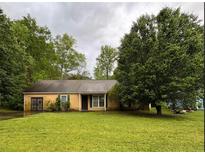 Charming single-story home with a well-maintained lawn and mature trees at 3040 Garnet Way, Atlanta, GA 30349