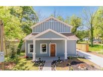 Charming home featuring a covered front porch, craftsman details, and a well-manicured front yard at 1302 Ladd St, Atlanta, GA 30310