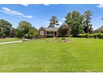 Charming brick home with a well-maintained front yard and beautiful landscaping at 3500 Thunderwood Ln, Snellville, GA 30039