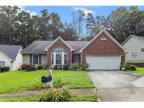 Charming single-story brick and siding home with a well-manicured lawn and attached two-car garage at 580 Lilburn School Rd, Lilburn, GA 30047