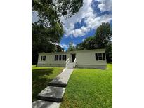 Well-maintained single-story home with a tidy front lawn and inviting entrance at 6830 Pawnee Trl Se, Acworth, GA 30102