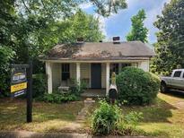 Exterior of charming single-story home with inviting front porch and lush landscaping at 2880 Elizabeth Se St, Smyrna, GA 30080