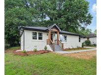Charming renovated home with white brick, stone accents, and a welcoming entry at 2244 Alpha Dr, Decatur, GA 30032
