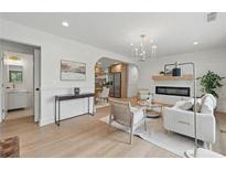 Bright living room with modern fireplace, chandelier, and an open view to the kitchen at 2244 Alpha Dr, Decatur, GA 30032