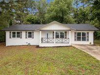 Charming renovated ranch-style home featuring a welcoming front porch and a freshly painted white brick facade at 8535 Hiram Acworth Hwy, Dallas, GA 30157