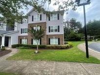 Attractive multi-story apartment building with landscaped grounds and manicured lawn at 14104 Fairington Circle Ridge, Stonecrest, GA 30038