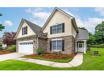 Charming home with stone accents, black shutters, manicured lawn, and inviting front entrance at 1000 Collingtree Ct, Mcdonough, GA 30253