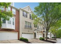 Charming townhome with well-manicured landscaping, attached garage and brick and painted facade at 11302 Musette Cir, Alpharetta, GA 30009