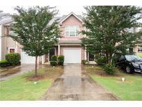Charming two-story townhouse with brick facade, attached garage, and well-maintained landscaping at 6010 Capitol Knl, Fairburn, GA 30213