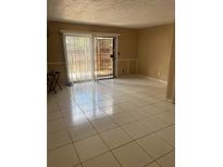 Bright living room featuring tile floors, sliding doors to the outside, and neutral walls at 1867 Myrtle Dr # 5, Atlanta, GA 30311