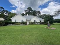 Charming stucco home featuring a lush green lawn and manicured landscaping at 333 Etoawha Vly, Woodstock, GA 30189