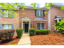 Charming brick townhome with black shutters and a well-maintained front yard at 3737 Town Square Nw Cir # 6, Kennesaw, GA 30144