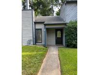 Charming home featuring a quaint front entry with a dark front door and well-maintained lawn at 267 Toweridge Sw Dr, Marietta, GA 30064