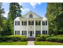 Classic white home featuring a columned porch and manicured landscaping at 3415 Habersham Nw Rd, Atlanta, GA 30305