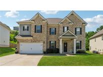 Charming two-story brick home featuring a well-manicured lawn and attached two car garage at 3711 Wartrace Dr, Atlanta, GA 30331