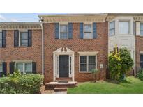 Charming brick townhome with a well-maintained front lawn and inviting entrance at 573 Hambrick Sq, Stone Mountain, GA 30083