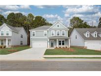 Charming two-story home with a manicured lawn and a welcoming front porch at 251 Arnewood Cir, Mcdonough, GA 30253
