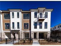Modern townhome exterior with brick and siding details plus a small balcony at 362 Olmstead Way # 23, Alpharetta, GA 30022