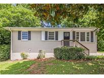 Charming single-story home with brick exterior, manicured lawn, and inviting front entrance at 1829 Goddard Se St, Atlanta, GA 30315