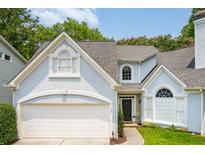 Charming two-story home with attached garage, a manicured lawn, and beautiful architectural detailing at 1241 Newbridge Trce, Brookhaven, GA 30319