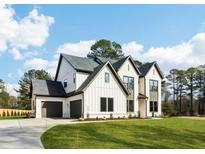 Charming two-story home with a three-car garage and well-manicured lawn at 3735 Tamiami Trl, Cumming, GA 30041
