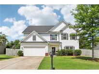 Charming two-story home with a well-maintained lawn and inviting curb appeal at 6160 Oriole Ln, Cumming, GA 30028