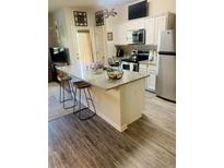 Modern kitchen features granite counters, stainless steel appliances, white cabinetry, and bar stool seating at 3589 Brycewood Dr, Decatur, GA 30034