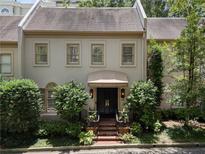 Charming townhome featuring a classic facade, well-manicured landscaping, and inviting entrance at 2525 Peachtree Rd # 28, Atlanta, GA 30305