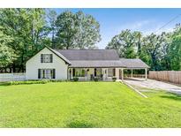 Charming home with well-maintained lawn, inviting front porch, and ample parking at 2896 Tiffany Cir, Lawrenceville, GA 30044