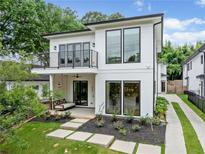 Modern two-story home featuring a balcony, porch with swing, sleek lines, and manicured landscaping at 32 Walthall Ne St # A, Atlanta, GA 30307