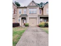 Charming townhome featuring a one car garage and well-maintained landscaping at 3645 Mcclaren Way, Lawrenceville, GA 30044