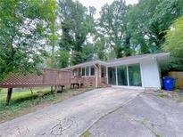 Charming brick home with a spacious driveway and inviting outdoor deck at 4103 Indian Creek Cir, Stone Mountain, GA 30083